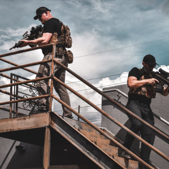 two men practicing self defense carrying firearms on the hub gun store mesa terrace