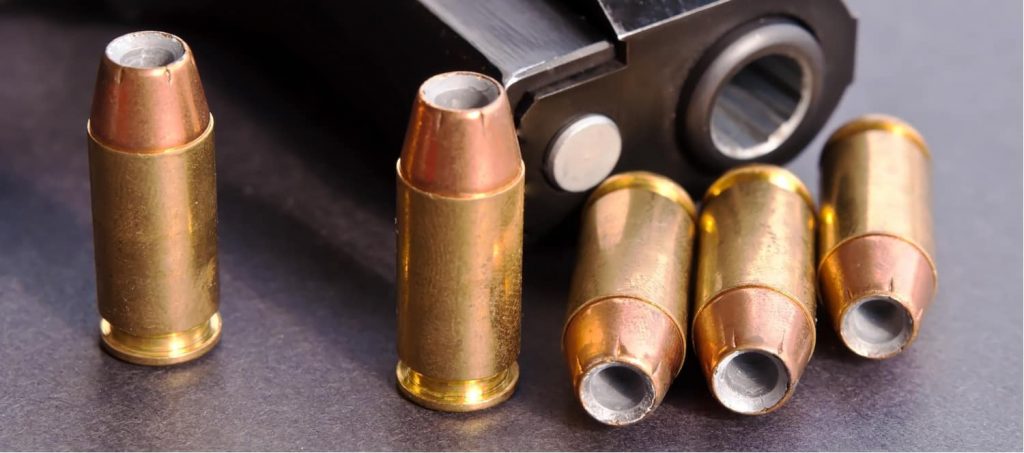 hollow point bullets next to a gun