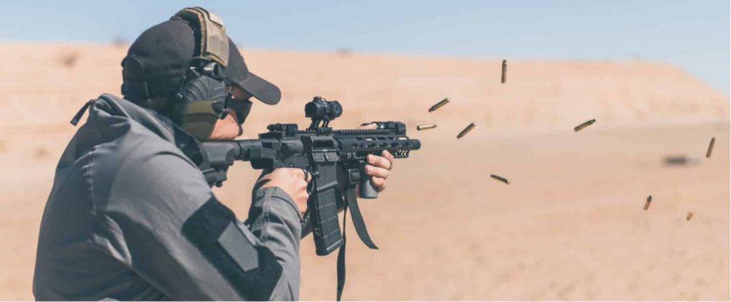 a man shooting an ar15 rifle that could use direct impingement or gas piston