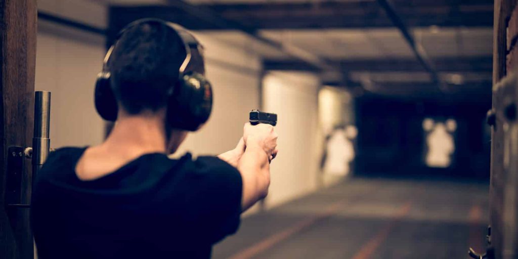 a man shooting at an indoor firing range