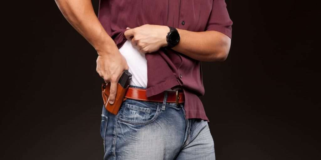 a man using the owb concealed carry method