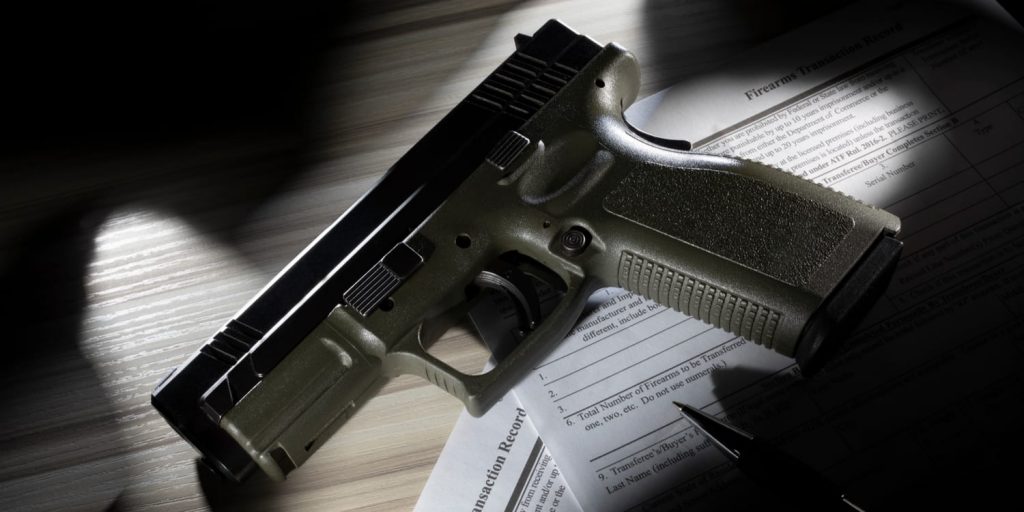 a handgun on top of atf forms