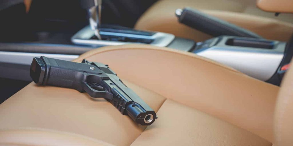 a gun on the seat of a car