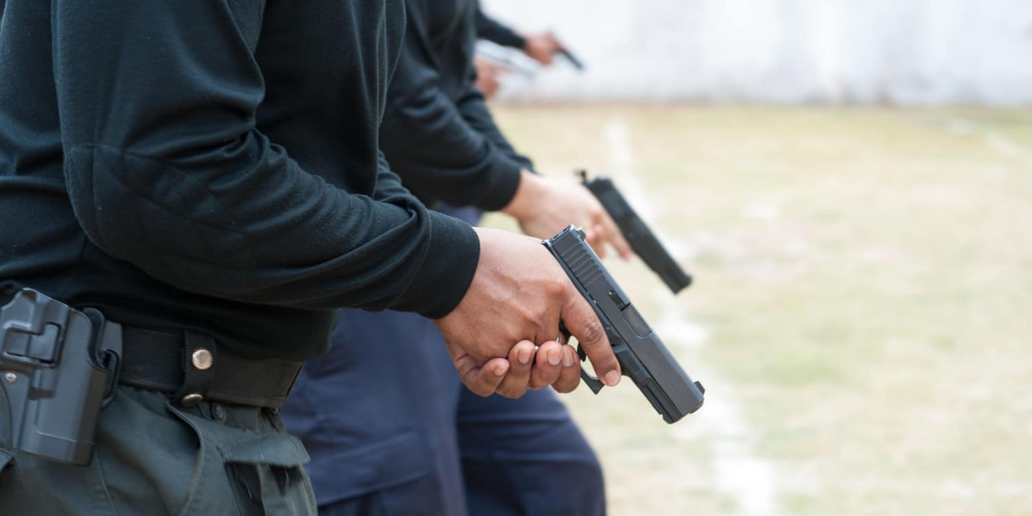 multiple people engaging in a gun training exercise