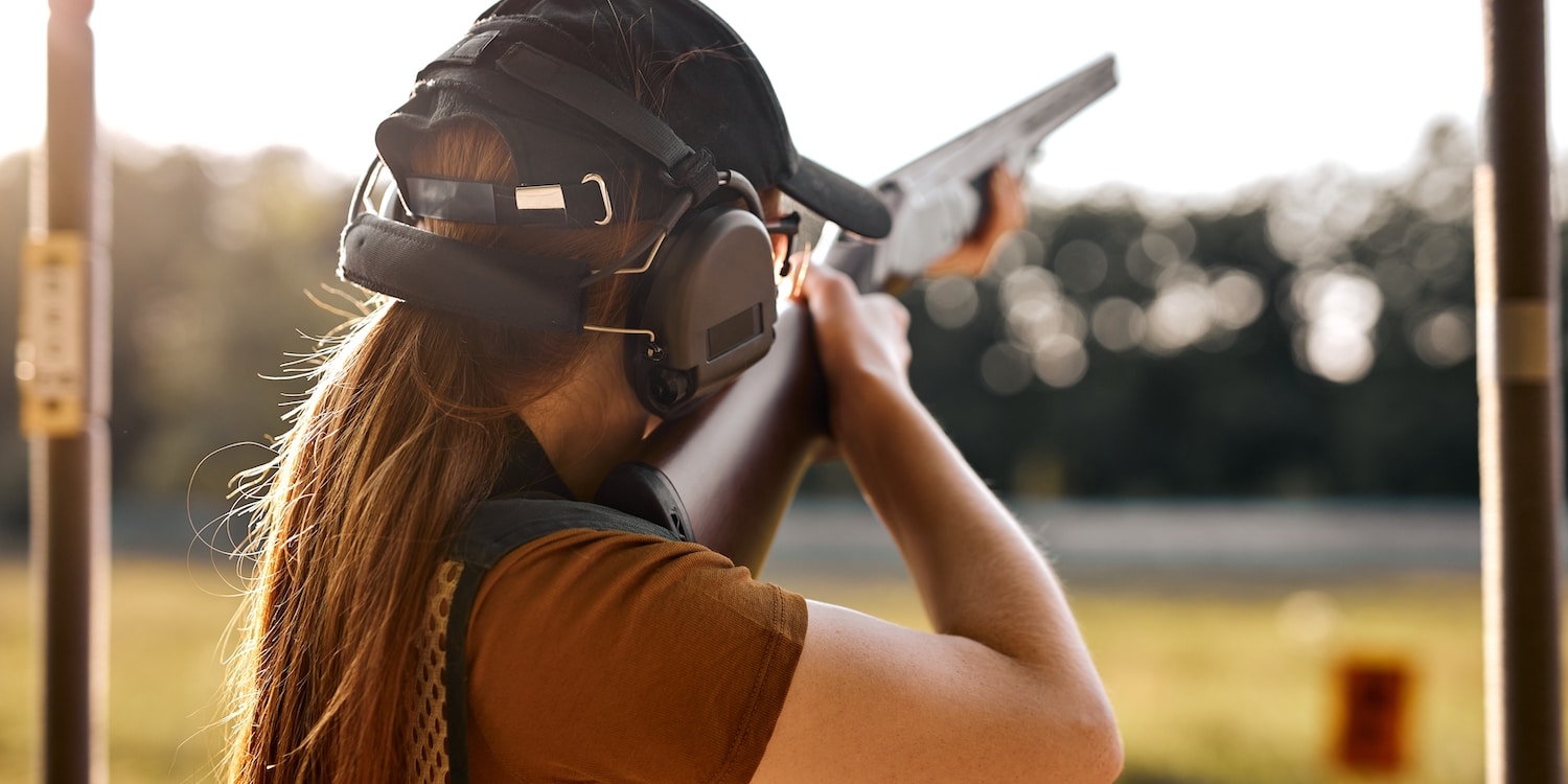 a woman engaging in shooting sports
