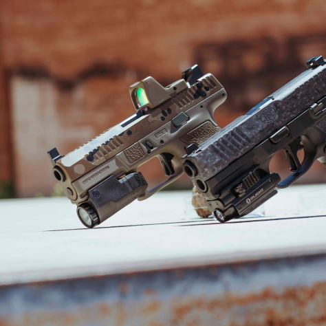 two pistols side by side with an upright position on the ground