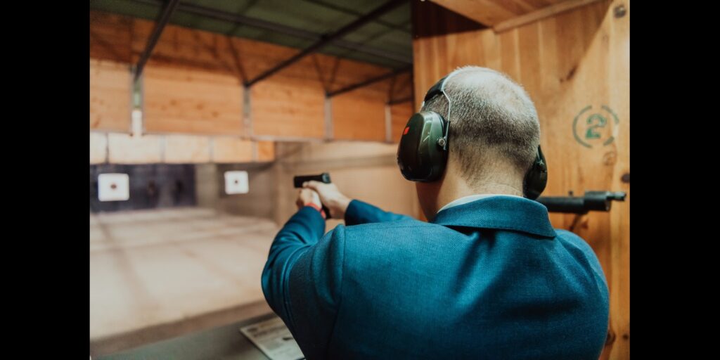 a man shooting at the hub gun range with a pistol