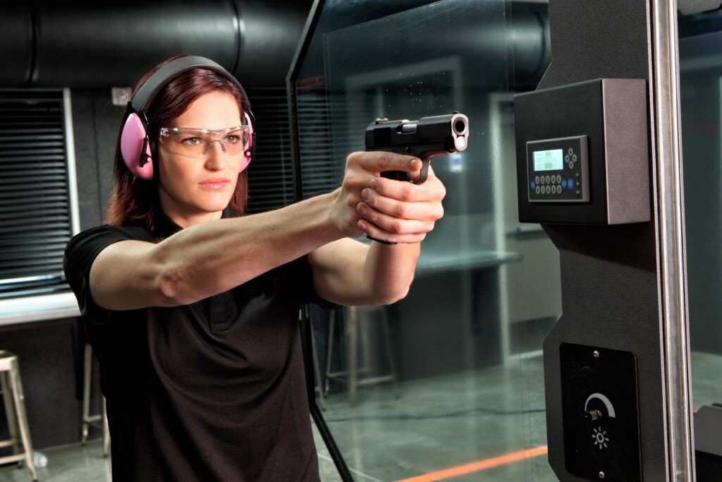 a girl who is a new gun owner practicing handgun range drills at the hub